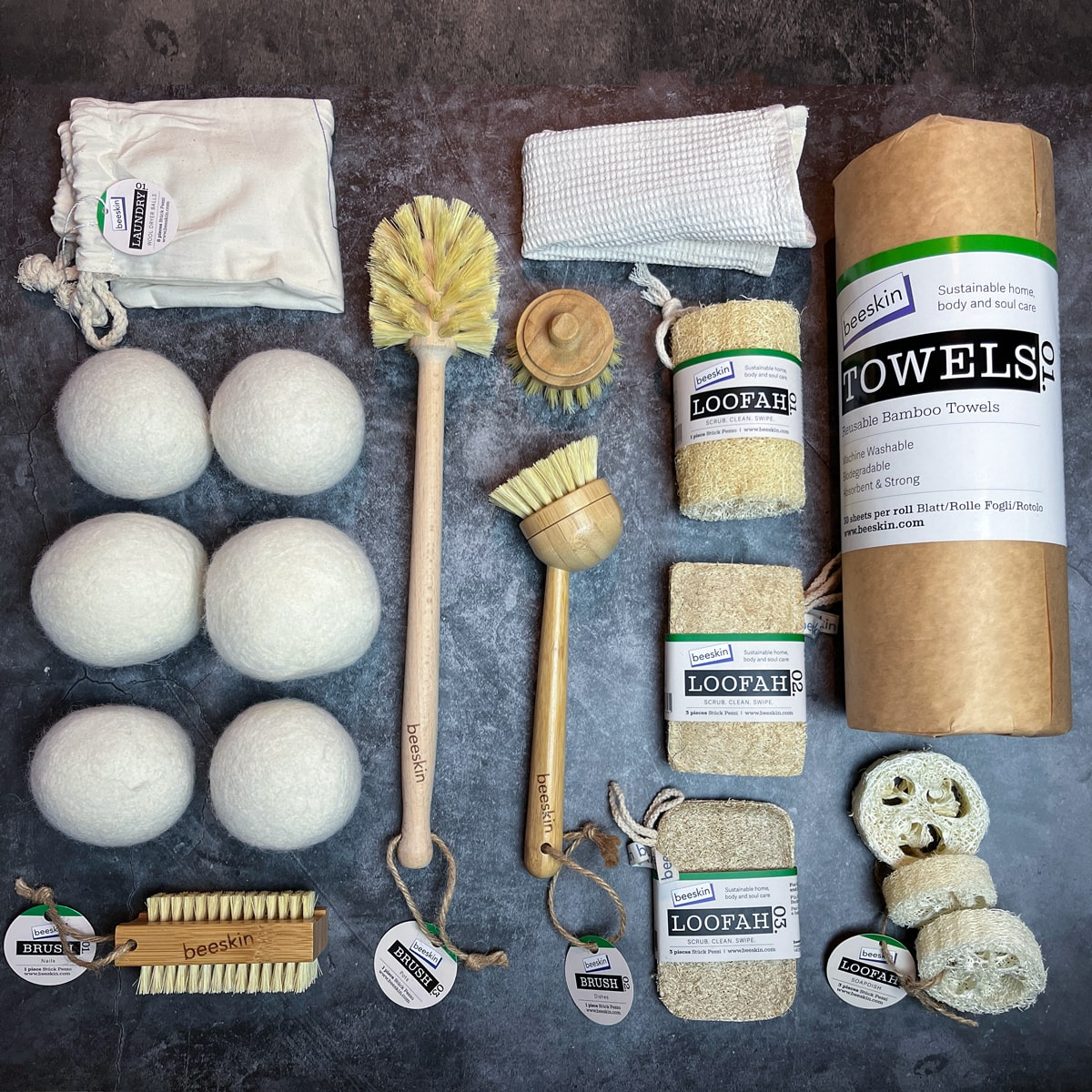 pictures on dark background showing bamboo towels. wool dryer balls. bamboo brushes. loofah sponges. bamboo nail brush.