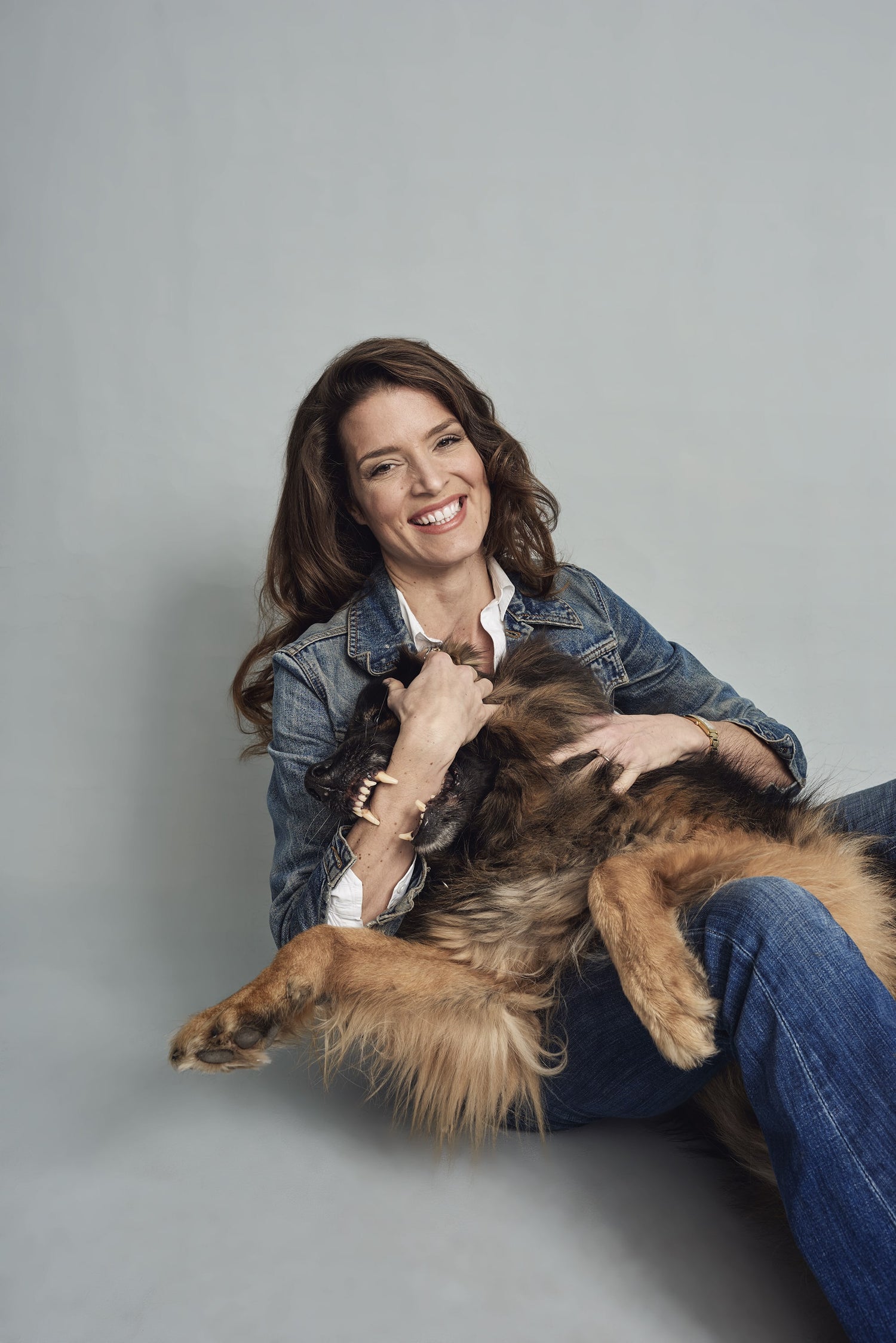 laughing Tina Sauer, CEO beeskin GmbH, with her German Shepard Dog