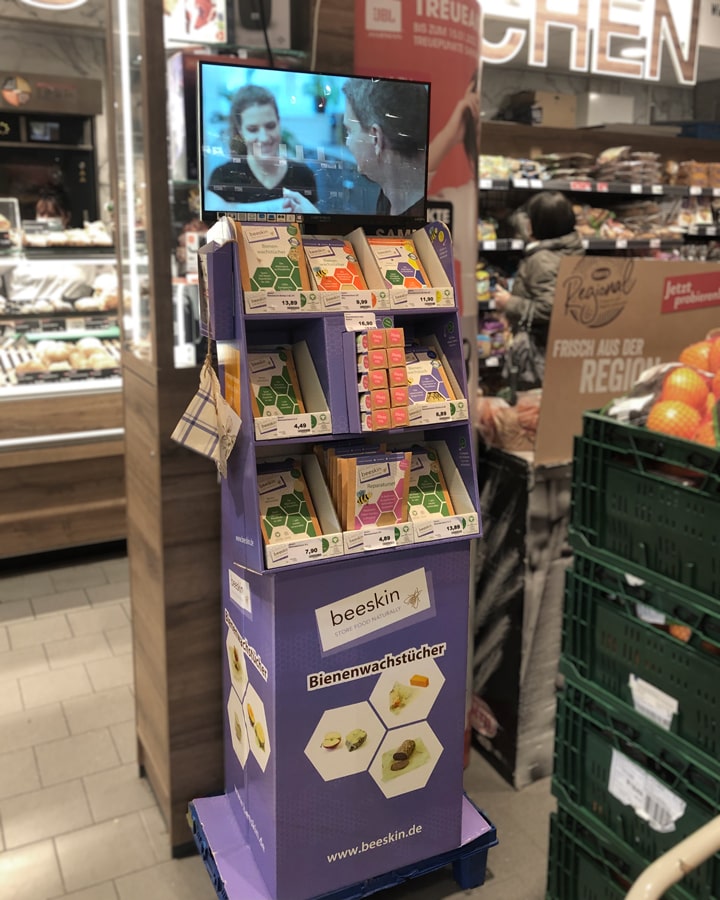 beeskin display with all beeswax wrap products with a TV screen showing a film