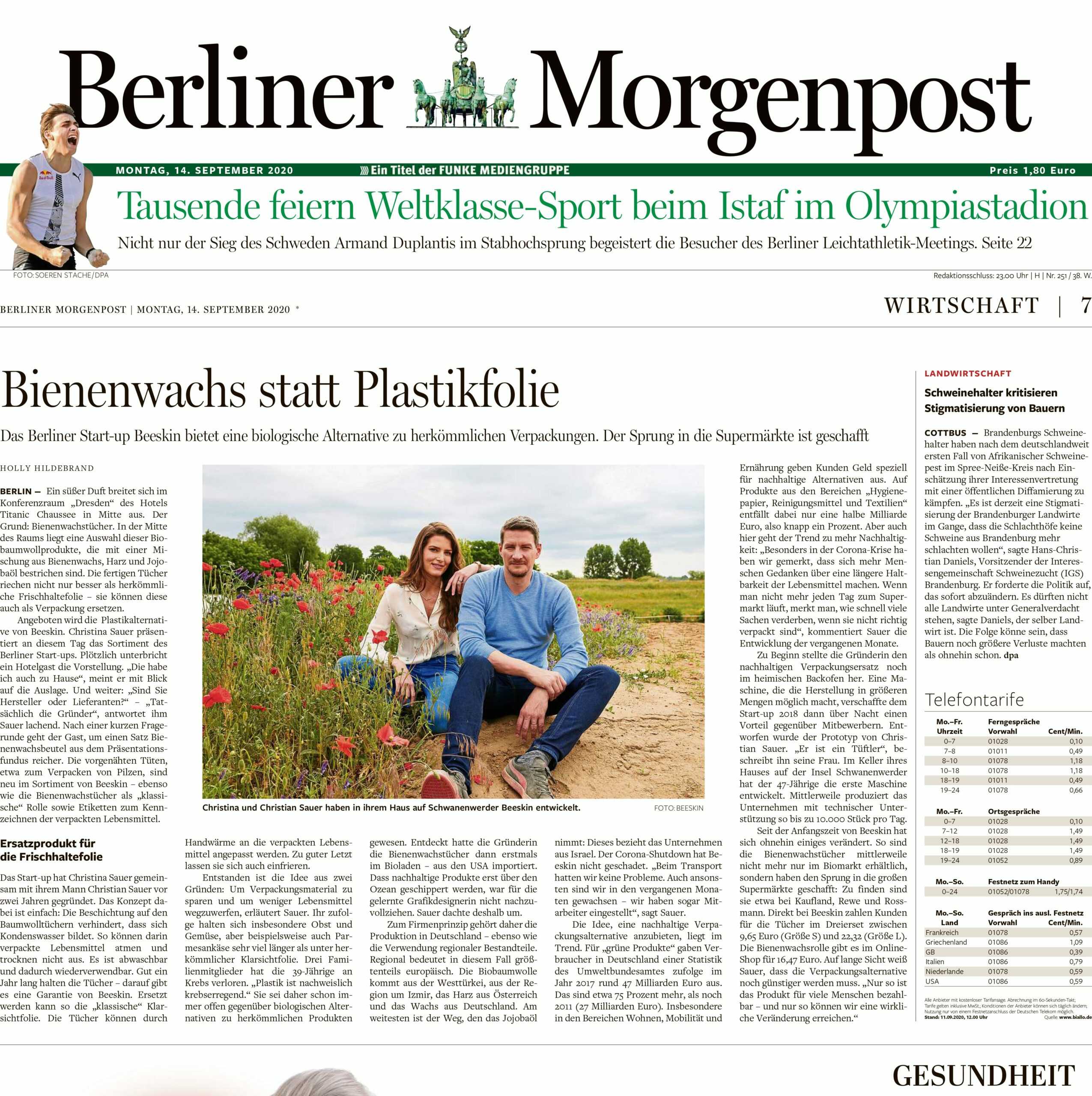 Berliner Morgenpost Artikel about beeskin, Christina and Christian Sauer sitting on a meadow with red flowers