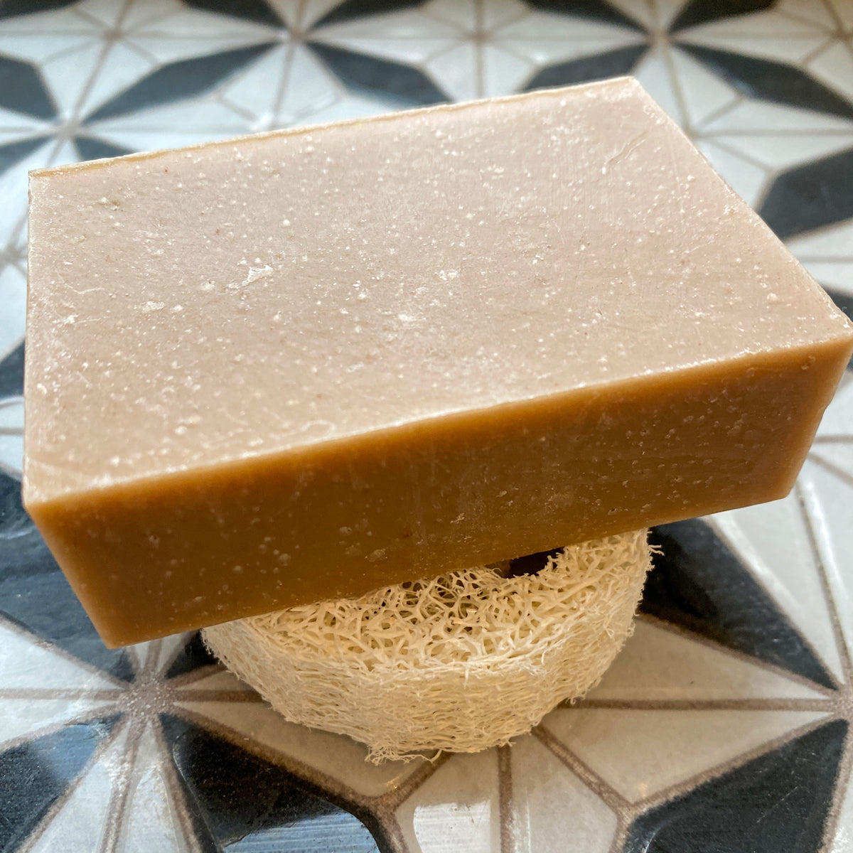 piece of soap lies on beeskin loofah