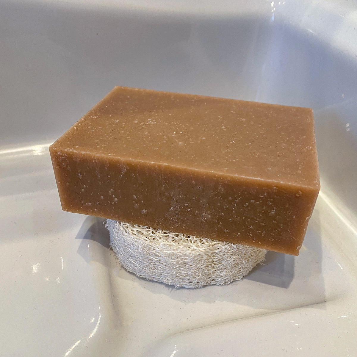 piece of soap lies on beeskin loofah to store