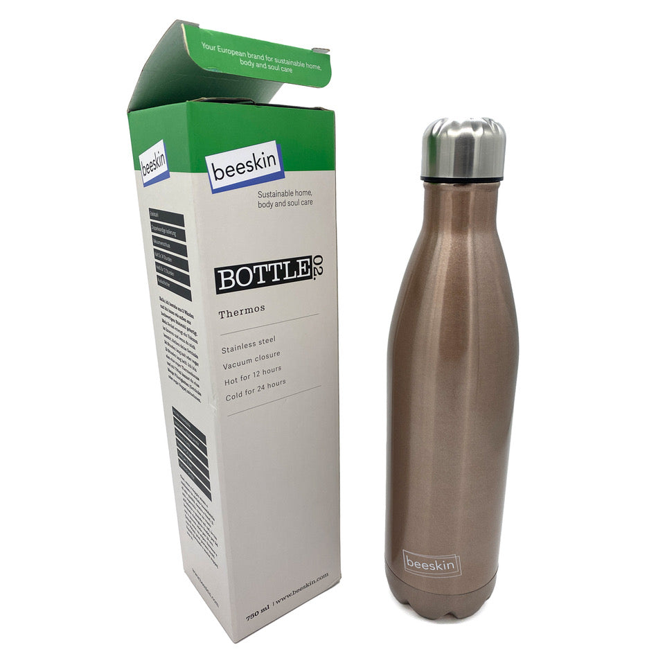 rose gold thermobottle with beeskin logo next to packaging