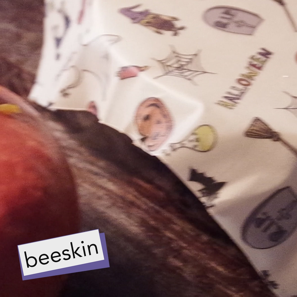 video hands cutting a pumpkin and wrapping it in beeskin halloween