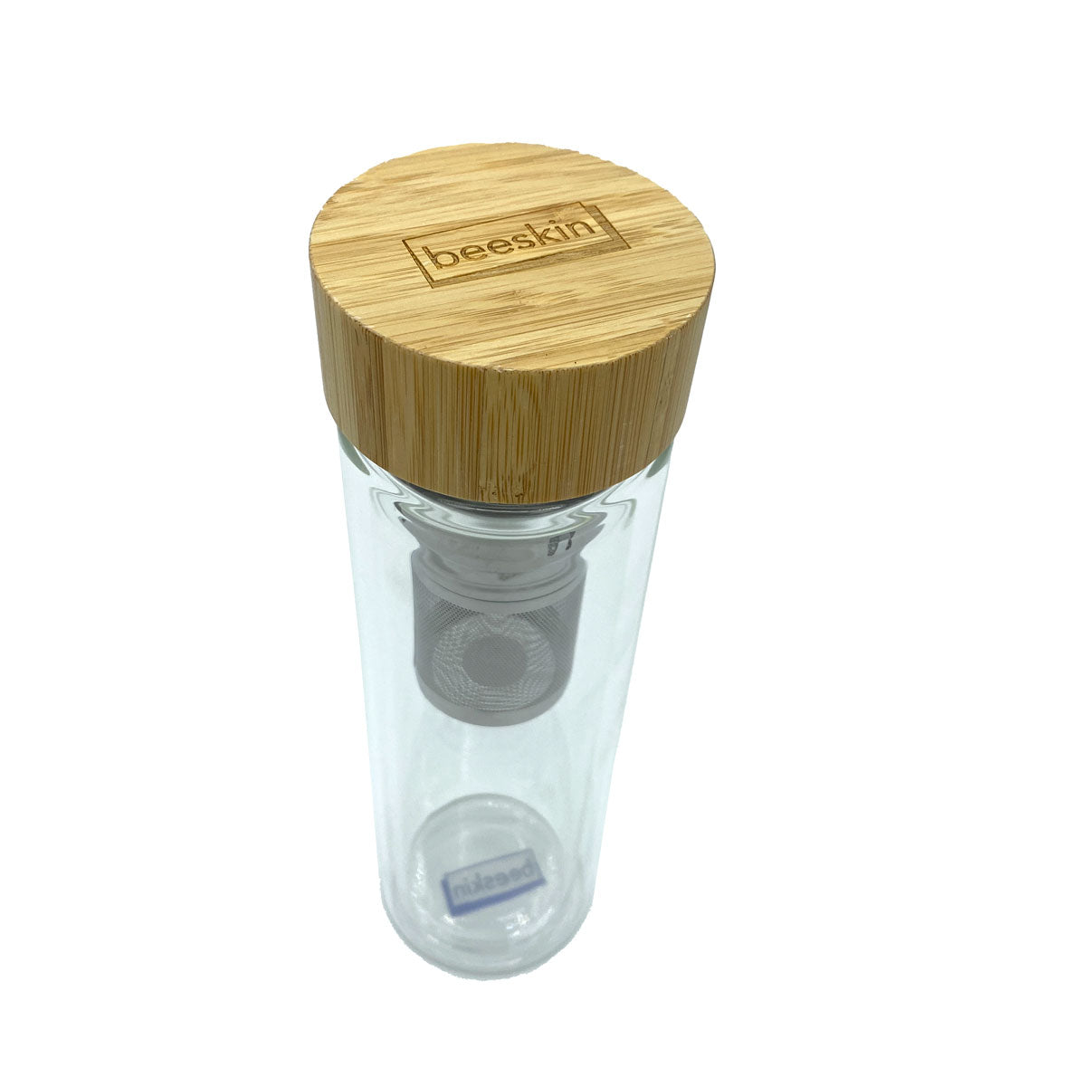 glass tea bottle from above with beeskin logo on wooden lid
