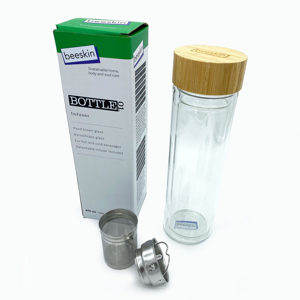 tea bottle infuser made of hand blown glas with tea strainer next to packaging