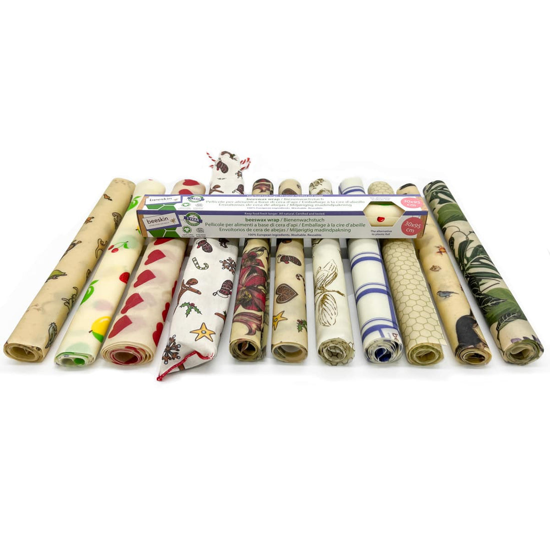 showing 11 different beeswax wrap rolls next to one another on white background.