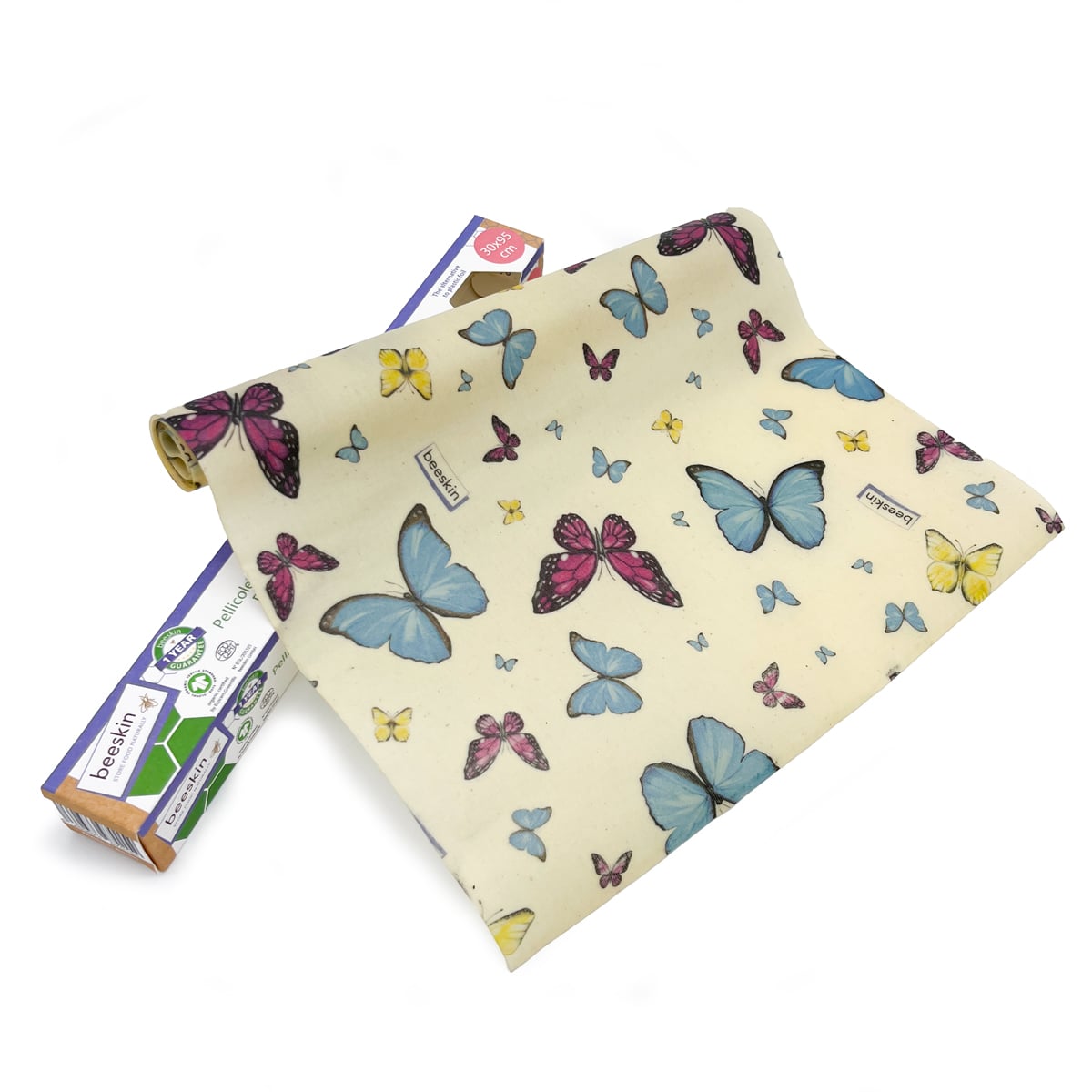 beeskin beeswax roll butterflies next to packaging