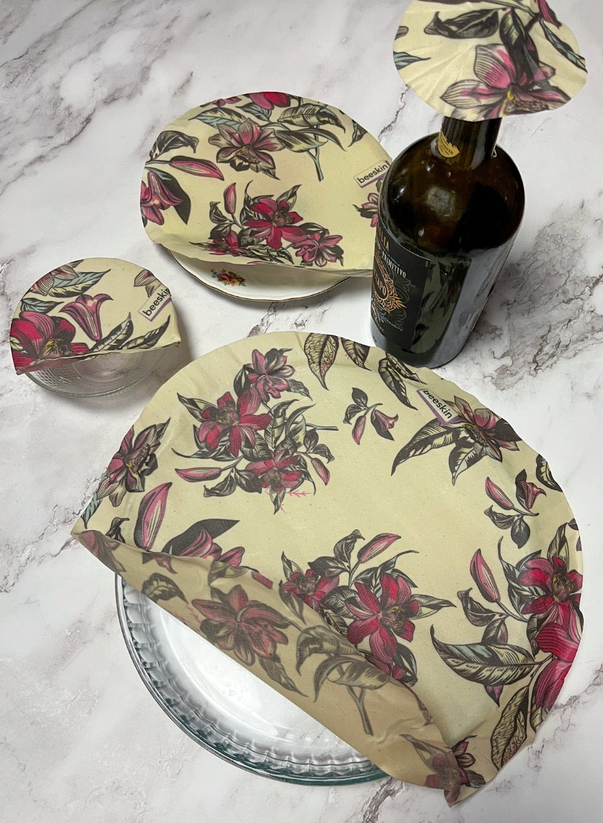 round beeskin beeswax set victorian flower on different plates and bowl and covering a wine bottle