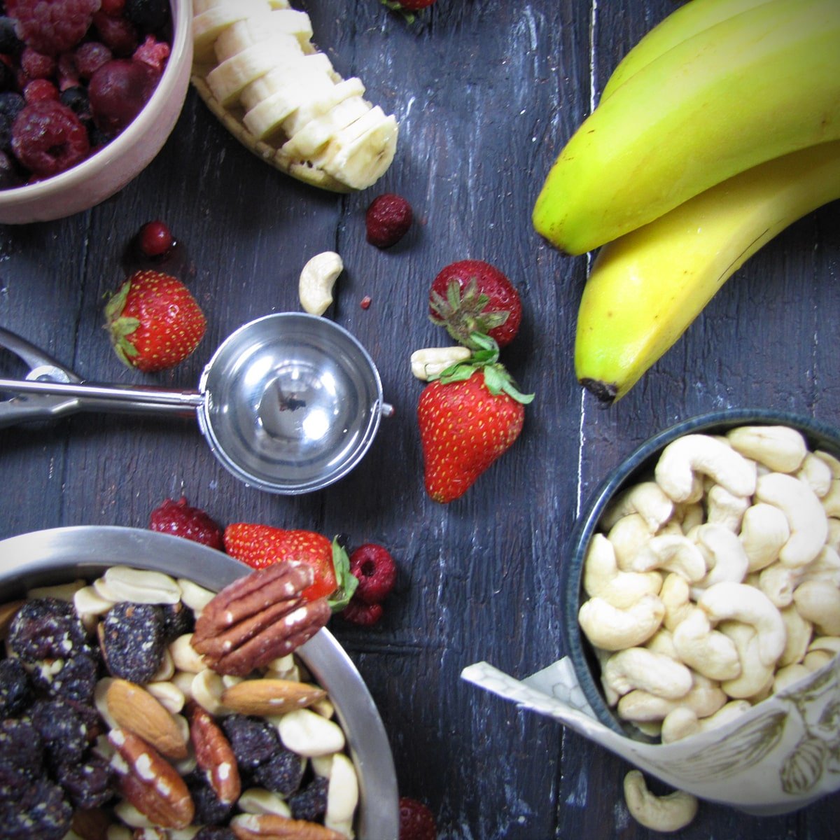photo showing ice cream scoop, various fruits and nuts to make vegan ice cream 