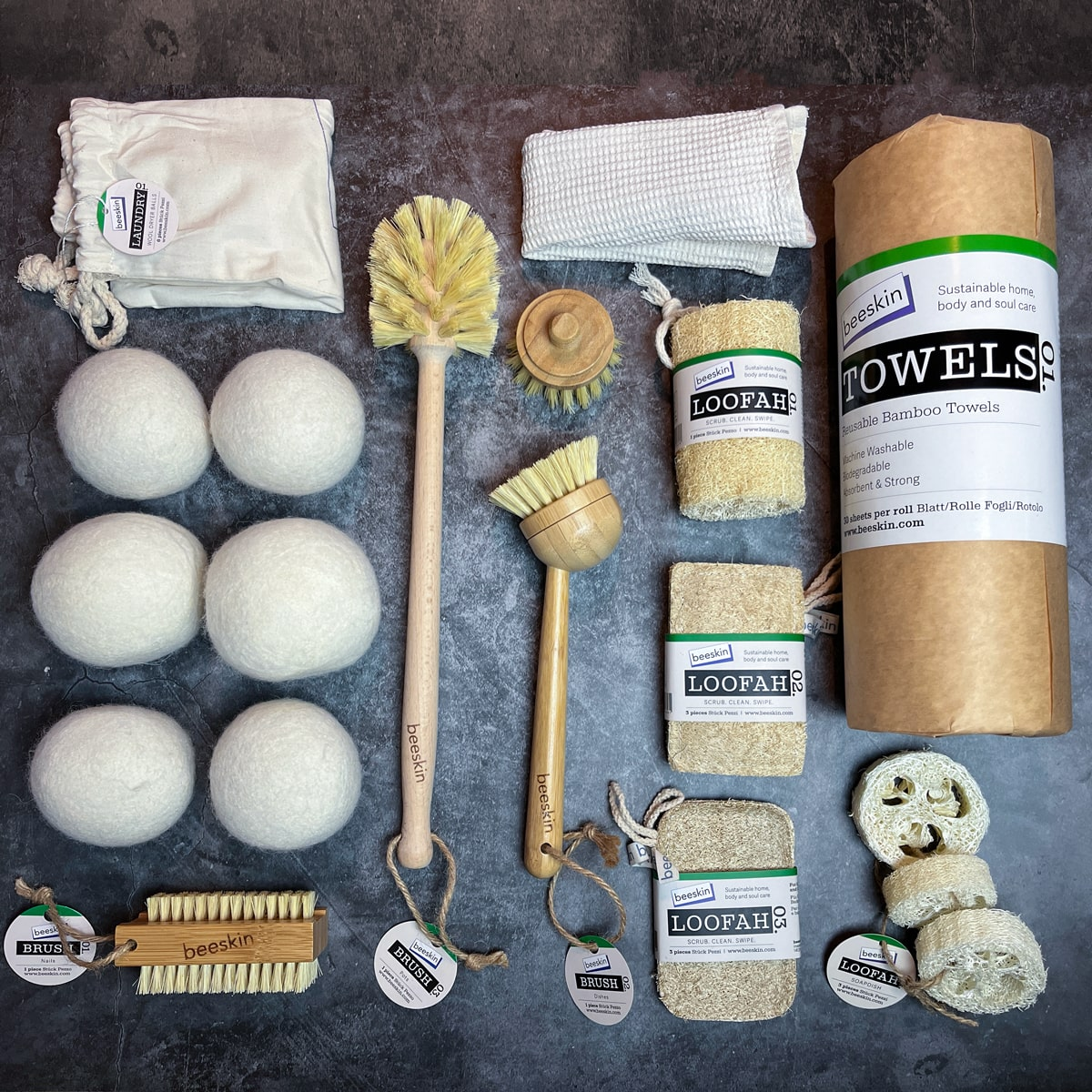 pictures on dark background showing bamboo towels. wool dryer balls. bamboo brushes. loofah sponges. bamboo nail brush. 