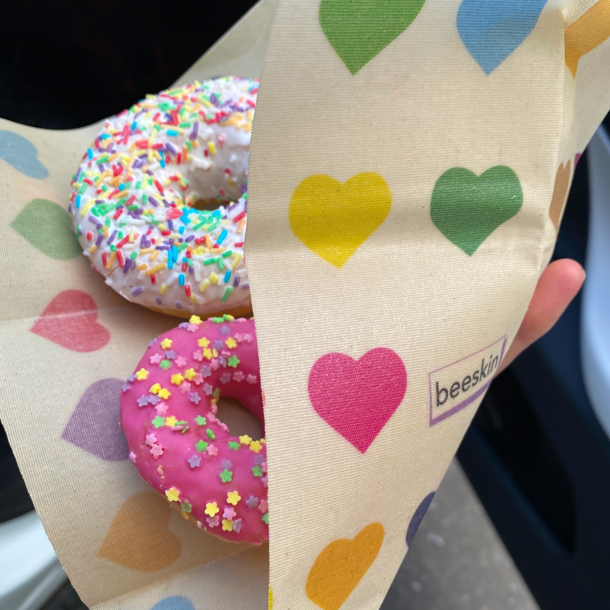 donuts with pink glaze and sprinkles wrapped in beeskin beeswax wrap colorful hearts