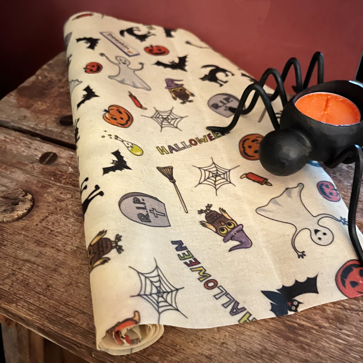 beeskin beeswax roll halloween and a spider with a candle standing on the wrap
