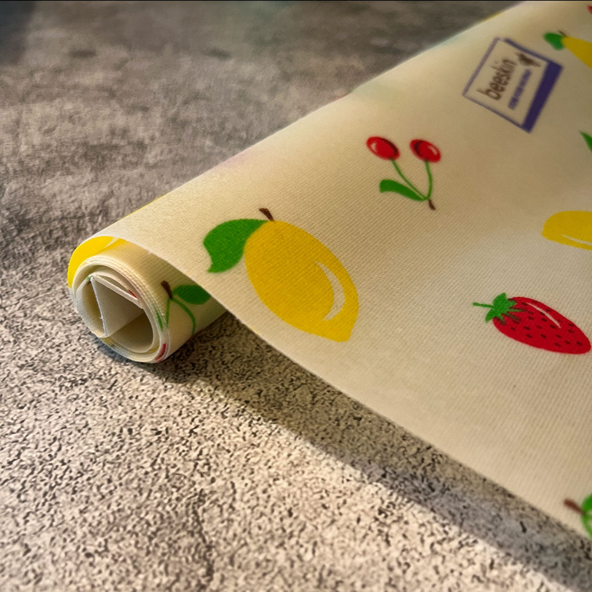 beeskin beeswax roll with fruits such as lemon, strawberry, cherry and bee ski. logo