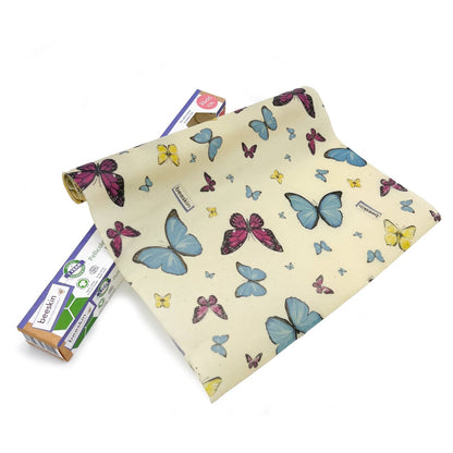 beeswax roll with butterflies next to package
