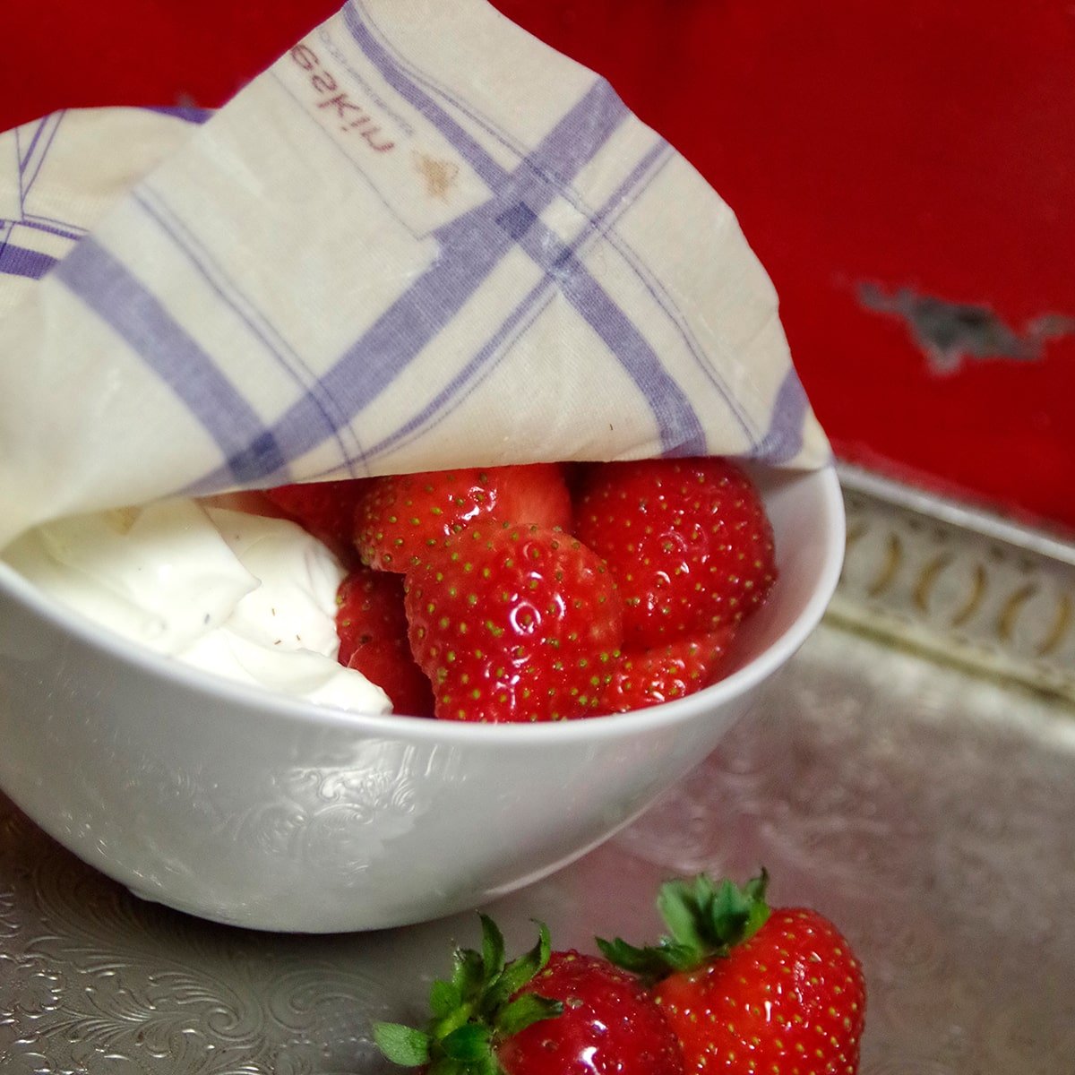 strawberries and whipped cream in a white bowl covered with beeskin beeswax wrap kitchen