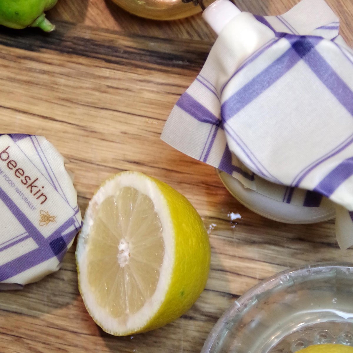 half lemon wrapped in beeskin and jar covered with beeswax wrap s kitchen