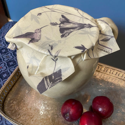 porcellaine jug on a tablet covered with beeswax wrap hummingbird