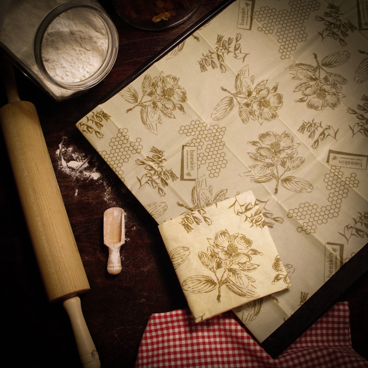 beeskin beeswax wrap xl flower that covers a baking tray next to baking accessories 