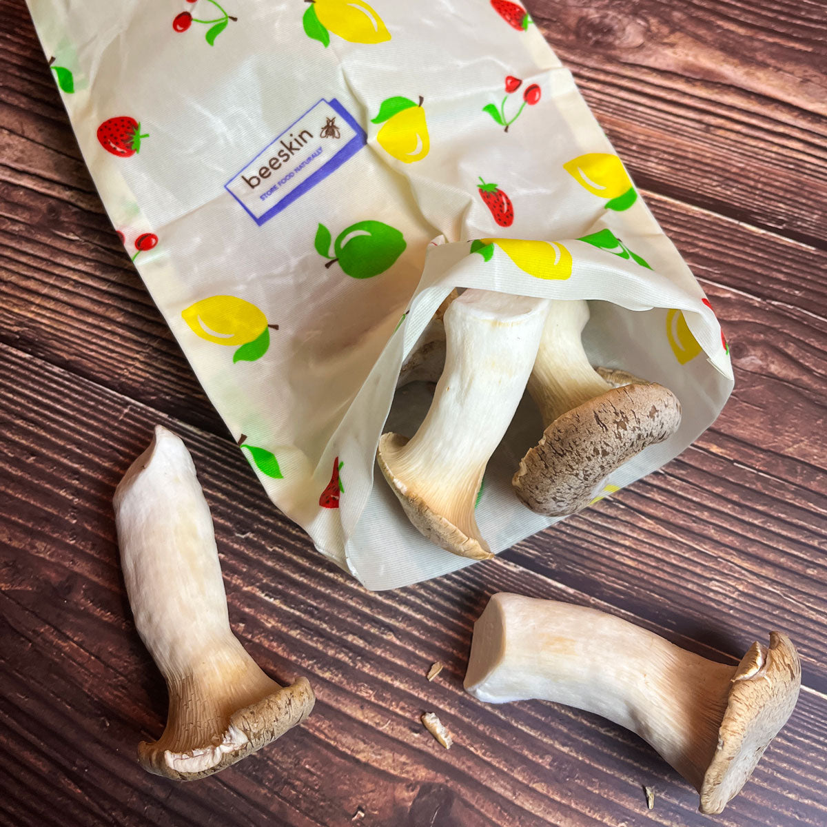 mushrooms in beeswax bag size s fruit design on a wooden table