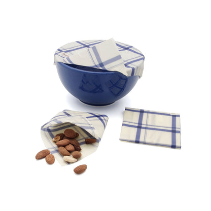 blue bowl covered with beeskin beeswax wrap kitchen and a folded envelope for nuts