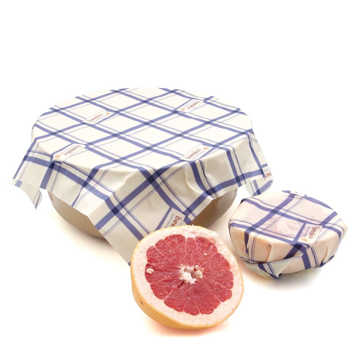 beeskin beeswax wrap ml kitchen covering a bowl and a grapefruit that is cut in 2 half