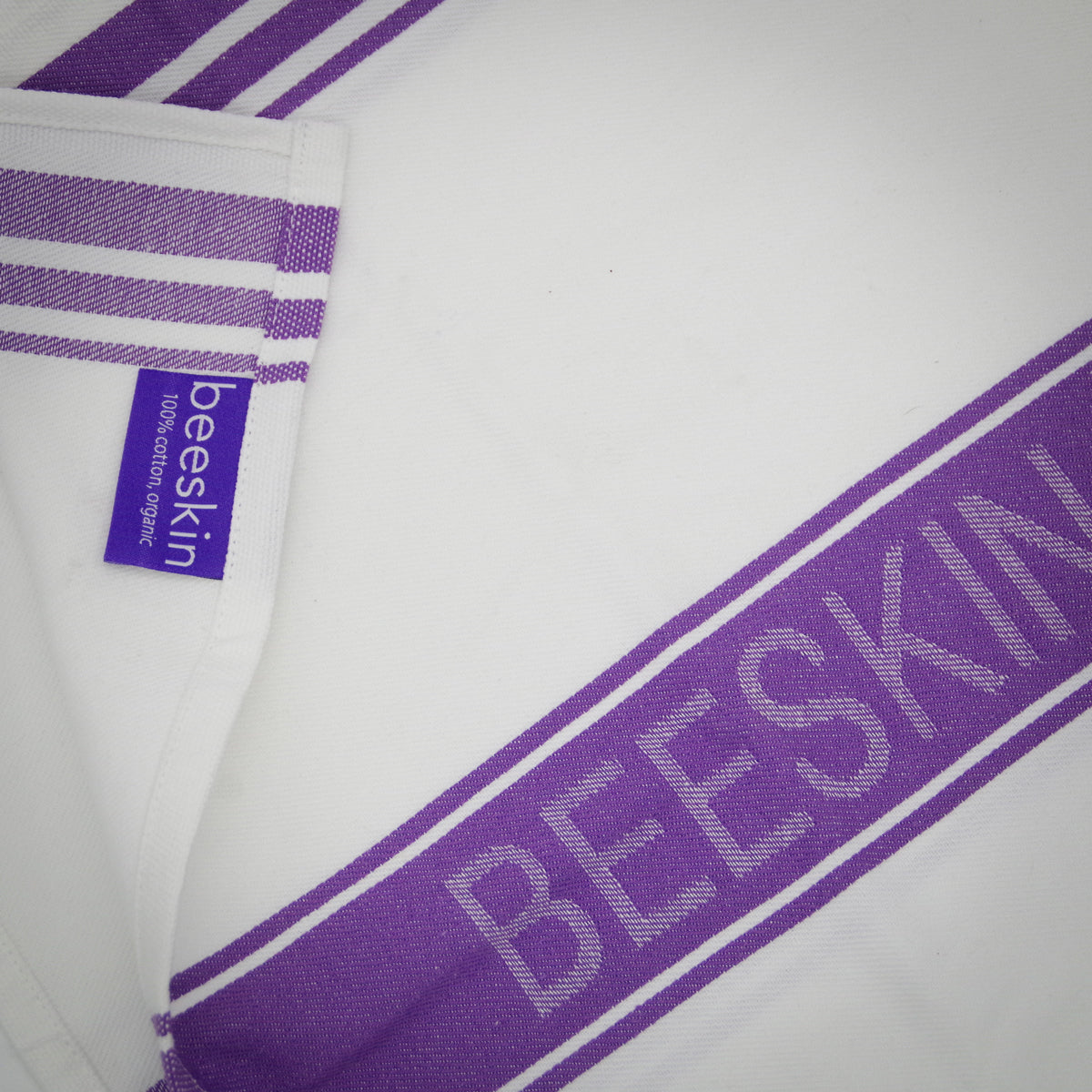 detail of tea towel with beeskin logo and label