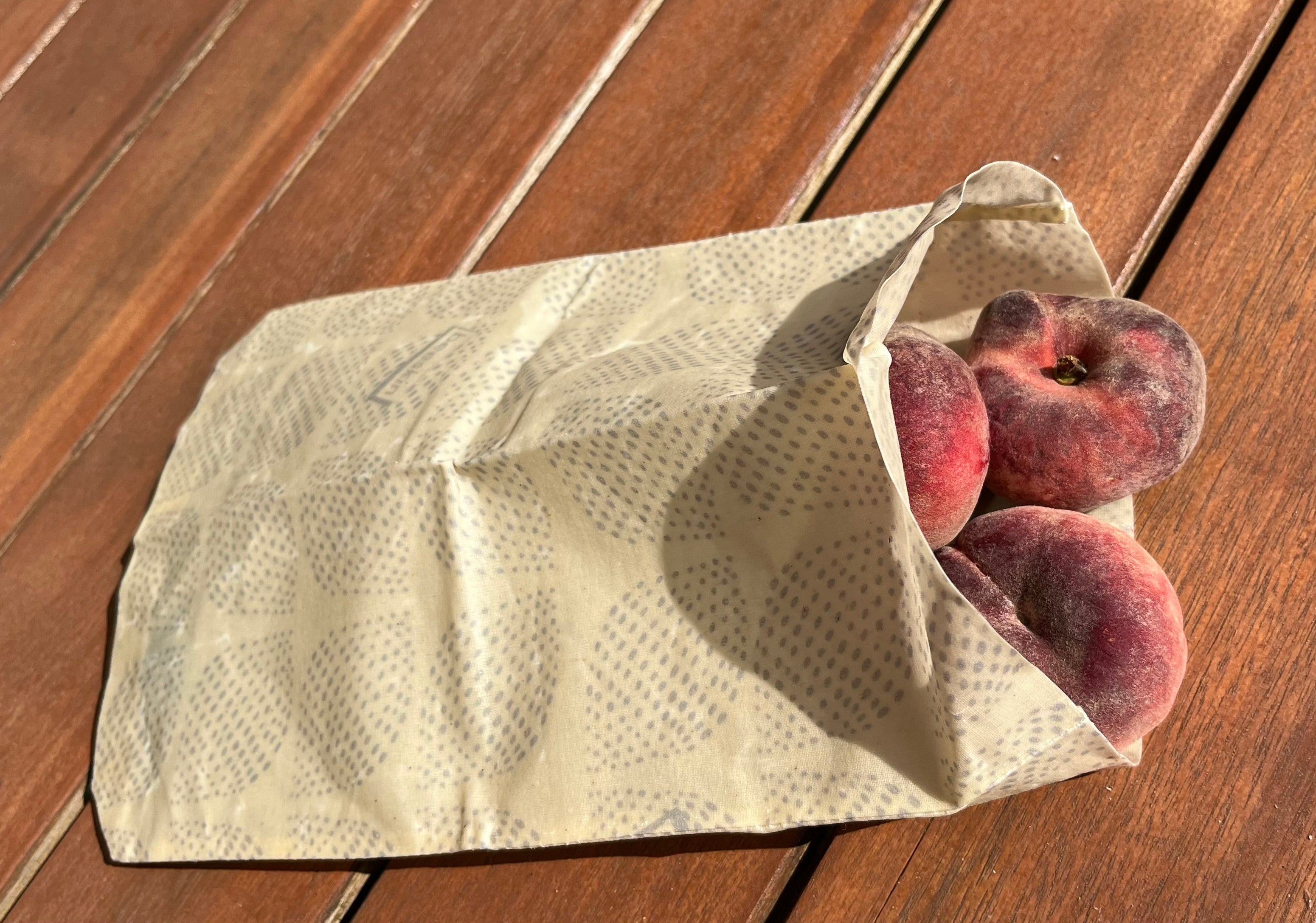 Bag S scandic design filled with peaches on a wooden table