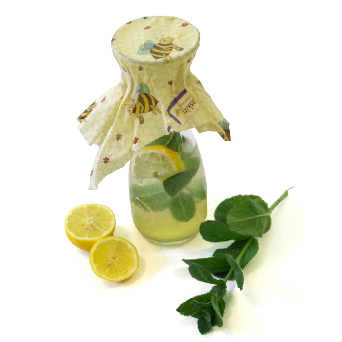 jar of water filled with lemon and fresh mint. covered with a beeskin m in kids design