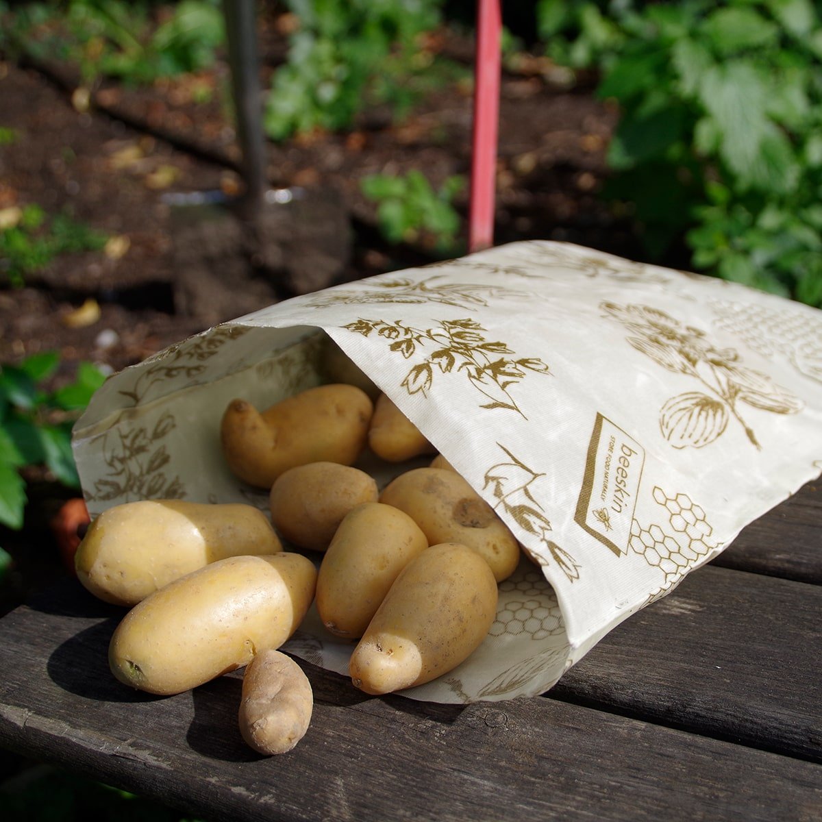 potatoes in an open beeskin bag size l flower on a chair standing near a patch