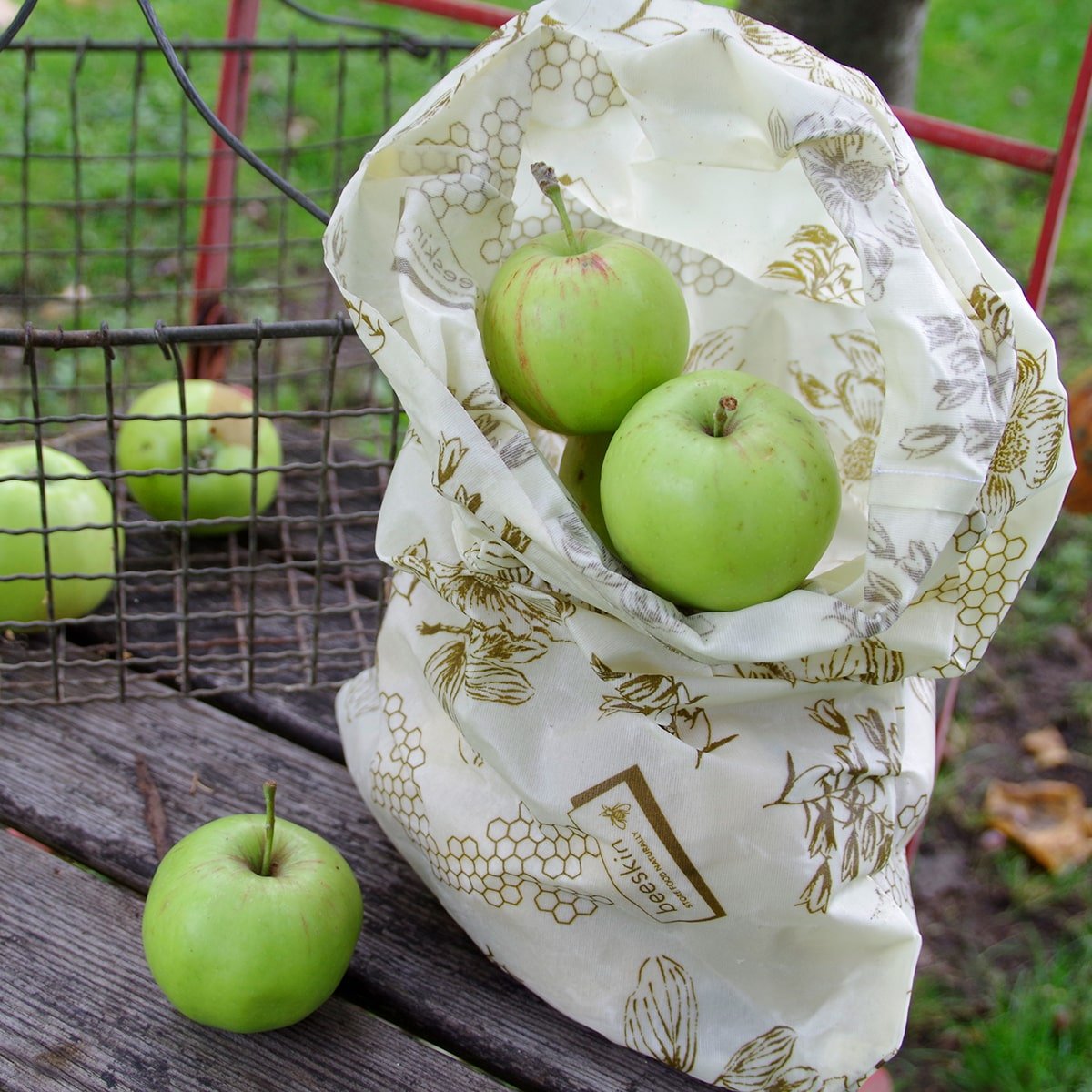 green apples in beeskin beeswax bag size l flower on a chair in the garden