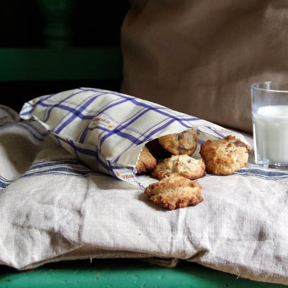 beeswax bag s kitchen with cookies lies on a linen towel next to it a glass of milk