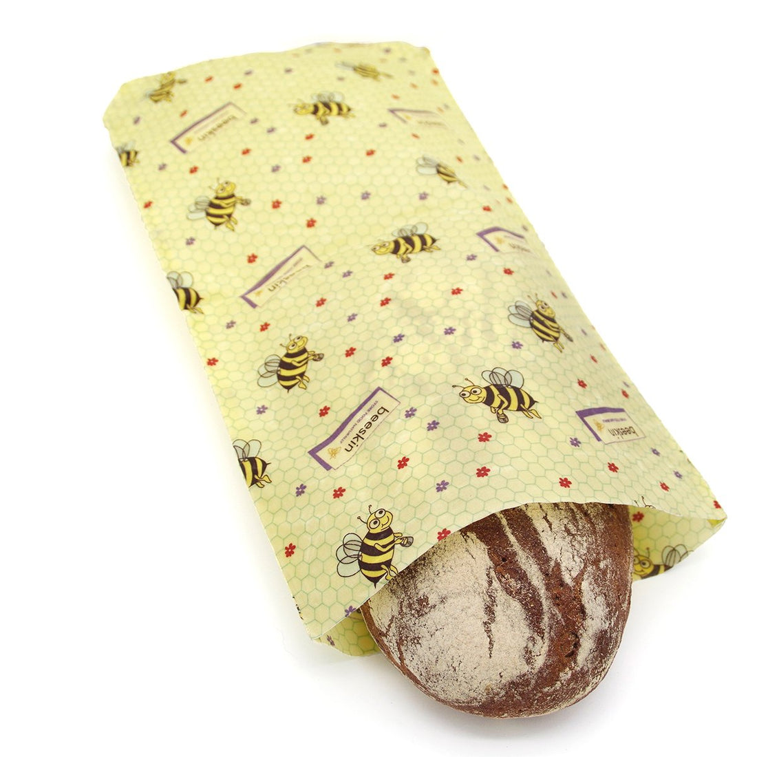 a loaf of bread is kept in a beeswax bag size l in kids design with bees and flowers