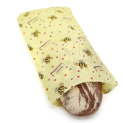 beeskin beeswax wrap bag size l in kids design containing a loaf of bread