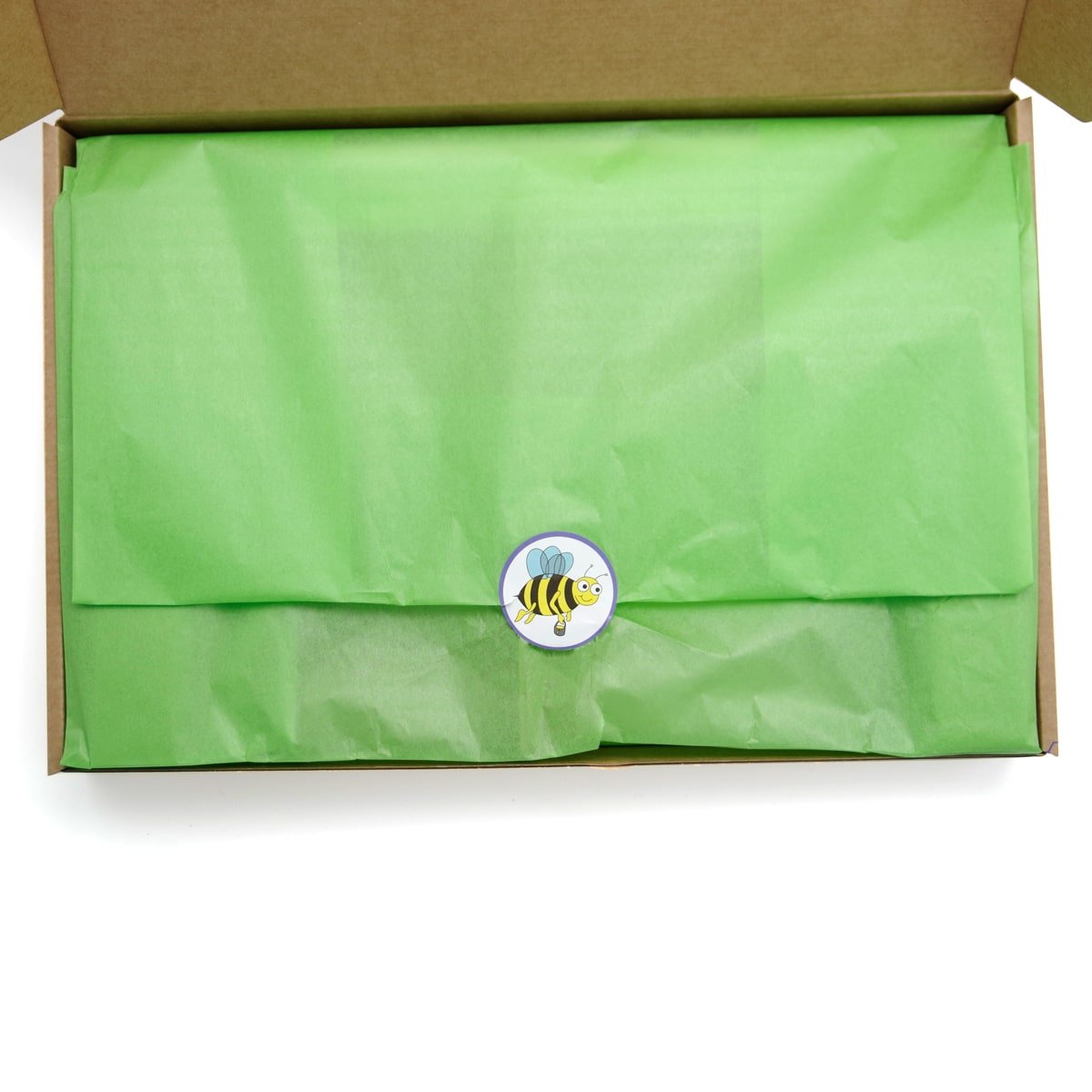 inside beeskin gift box green paper and sticker with a bee on it 