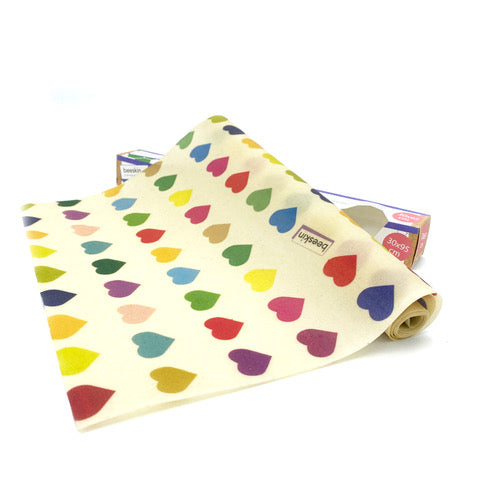 beeskin beeswax roll colorful hearts next to packaging